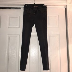 Black distressed skinny jeans with zipper detail
